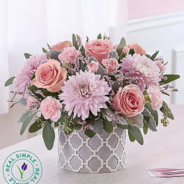 Pink roses and chrysanthemums in a patterned vase