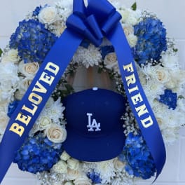 Blue and white floral wreath with a ribbon and baseball cap