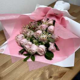 Pink rose bouquet wrapped in pink and white paper