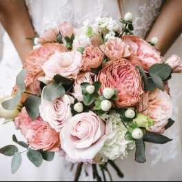 Pink and peach bridal bouquet with white accents and eucalyptus
