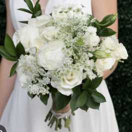 White rose bridal bouquet with baby's breath and greenery