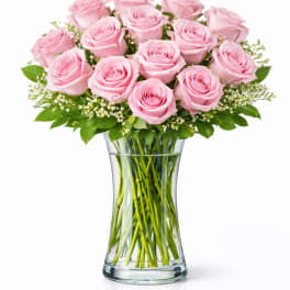 Pink roses arranged in a clear glass vase