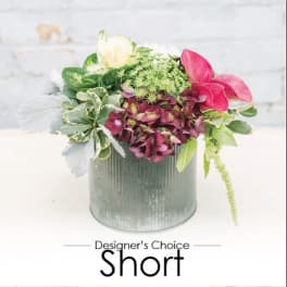 Mixed pink and white flowers in a gray metal container