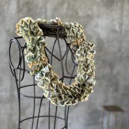 Money lei draped over a metal dress form