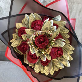 Bouquet of red roses wrapped with folded dollar bills and black-red paper