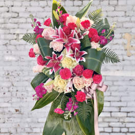 Pink and cream floral standing arrangement with lilies and roses