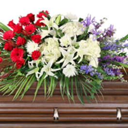 Casket spray with red, white, and purple flowers