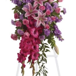 Tall standing floral spray with pink lilies, roses, and purple flowers