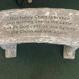 Stone memorial plaque with an engraved family remembrance message