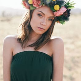 Woman wearing a floral crown with pink and yellow flowers
