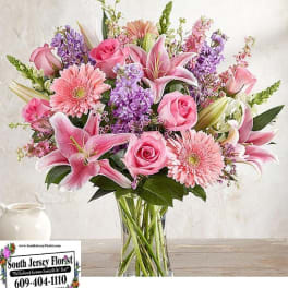 Pink and purple mixed bouquet in a clear glass vase