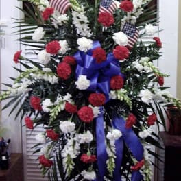 Standing floral spray with red and white carnations and small American flags