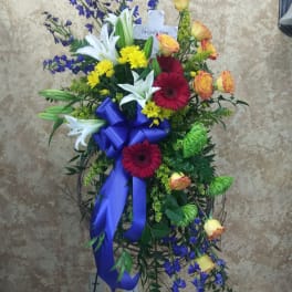 Standing sympathy spray with lilies, roses, and gerbera daisies