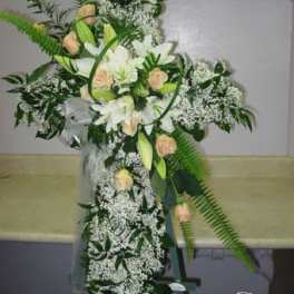 Tall white floral standing spray with peach roses and lilies