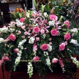 Large pink and white funeral spray with roses and lilies