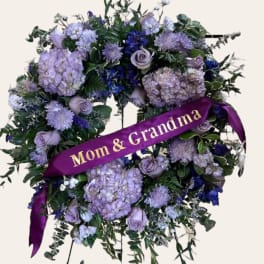 Purple floral standing wreath with a "Mom & Grandma" ribbon