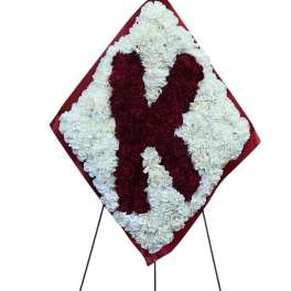 Heart-shaped floral standing spray in red and white on an easel