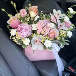 Pink and white bouquet in a pink gift box with a butterfly pick