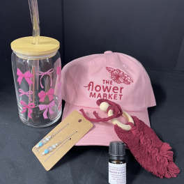 Pink flower market cap with a clear tumbler, earrings, tassel keychain, and small bottle