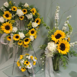 Sunflower and white rose floral arrangements with ribbon accents