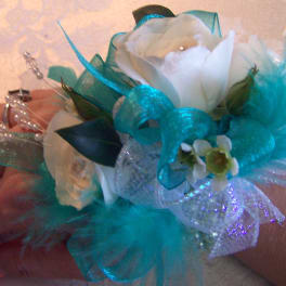 White rose corsage with turquoise ribbon and feathers