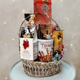 Gift basket with assorted chocolates and wafer cookies in a woven basket