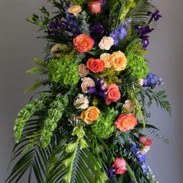 Tall floral spray with roses, hydrangeas, and purple blooms