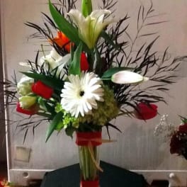 Tall bouquet with white lilies, red roses, and a white daisy