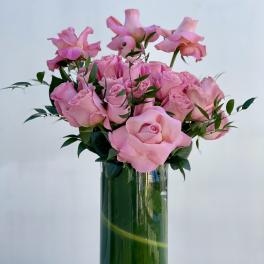 Pink roses arranged in a clear glass vase