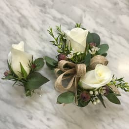 White rose boutonniere and matching wrist corsage with greenery and burlap ribbon