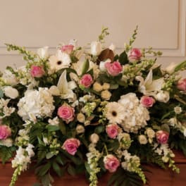 Large white and pink floral casket spray with lilies and roses