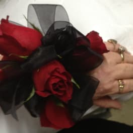 Red rose wrist corsage with black ribbon