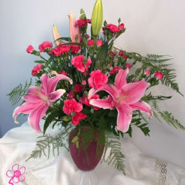 Pink lilies and carnations arranged in a vase