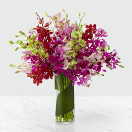 Colorful orchid bouquet in a clear glass vase
