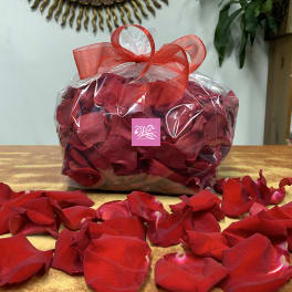 Bag of red rose petals tied with a red ribbon