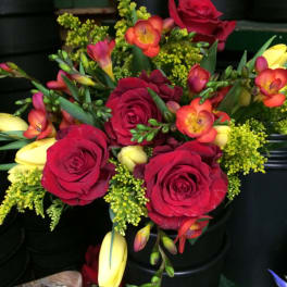 Bouquet of red roses with yellow and orange freesia