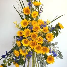 Tall sunflower arrangement with blue accent flowers