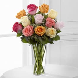 Bouquet of multicolored roses in a clear glass vase