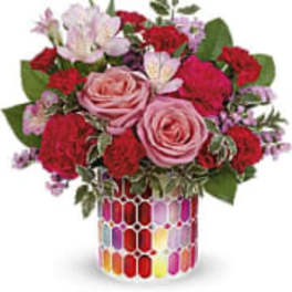 Pink and red rose bouquet in a colorful mosaic vase