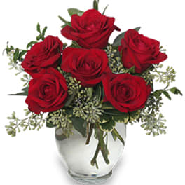 Arrangement of red roses in a clear glass vase