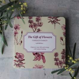 Floral-patterned book titled "The Gift of Flowers" on a gray surface