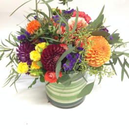 Colorful mixed bouquet in a striped ceramic pot