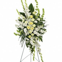 White and pale yellow funeral spray on a standing easel