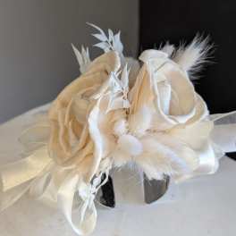 All white dried cuff corsage with silver band.