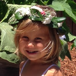 Child wearing a flower crown outdoors