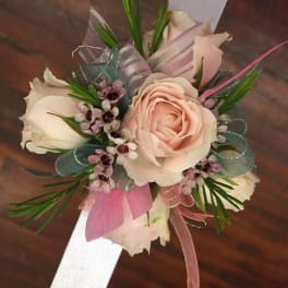 Corsage with pale pink roses and ribbon accents