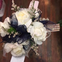 White rose corsage with navy ribbon and silver accents