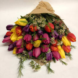 Bouquet of multicolored tulips wrapped in burlap