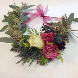 Heart-shaped floral wreath with pink roses and a ribbon bow