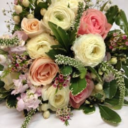 Bouquet of pink and cream roses with white ranunculus